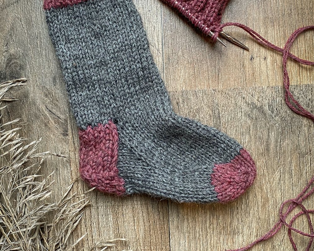 Folded socks beside rubber boots