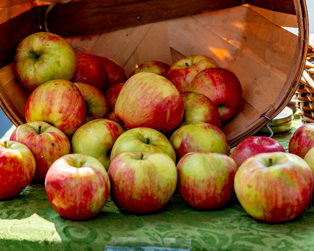 Crate with apples, jug and jar