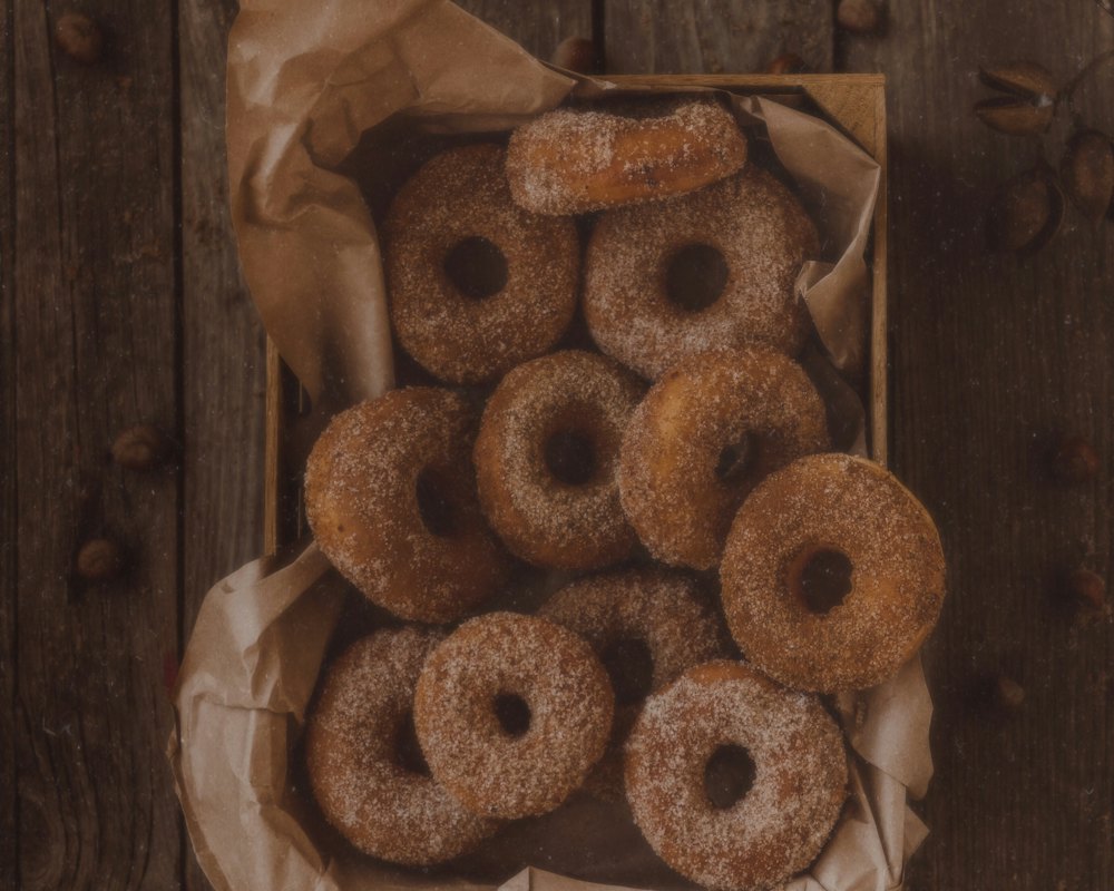 Cider donuts in a paper bag, sugar dusting