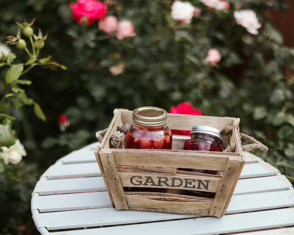 Small wooden crate packed with jars and straw