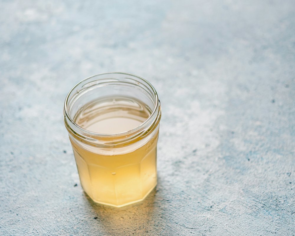 Amber jelly jar held to the light