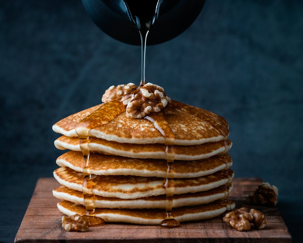 Syrup bottle beside a stack of pancakes